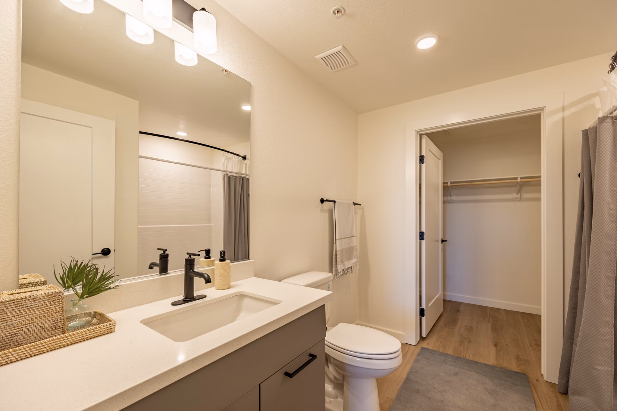 Modern bathroom with sleek fixtures at Alma Apartments featuring luxury finishes and ample lighting