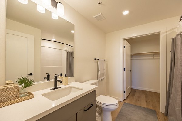 Modern bathroom with sleek fixtures at Alma Apartments featuring luxury finishes and ample lighting