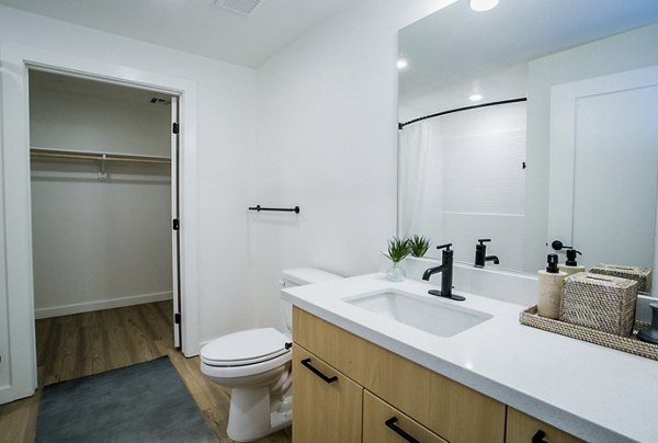 Bathroom featuring modern fixtures and elegant design at Alma Apartments