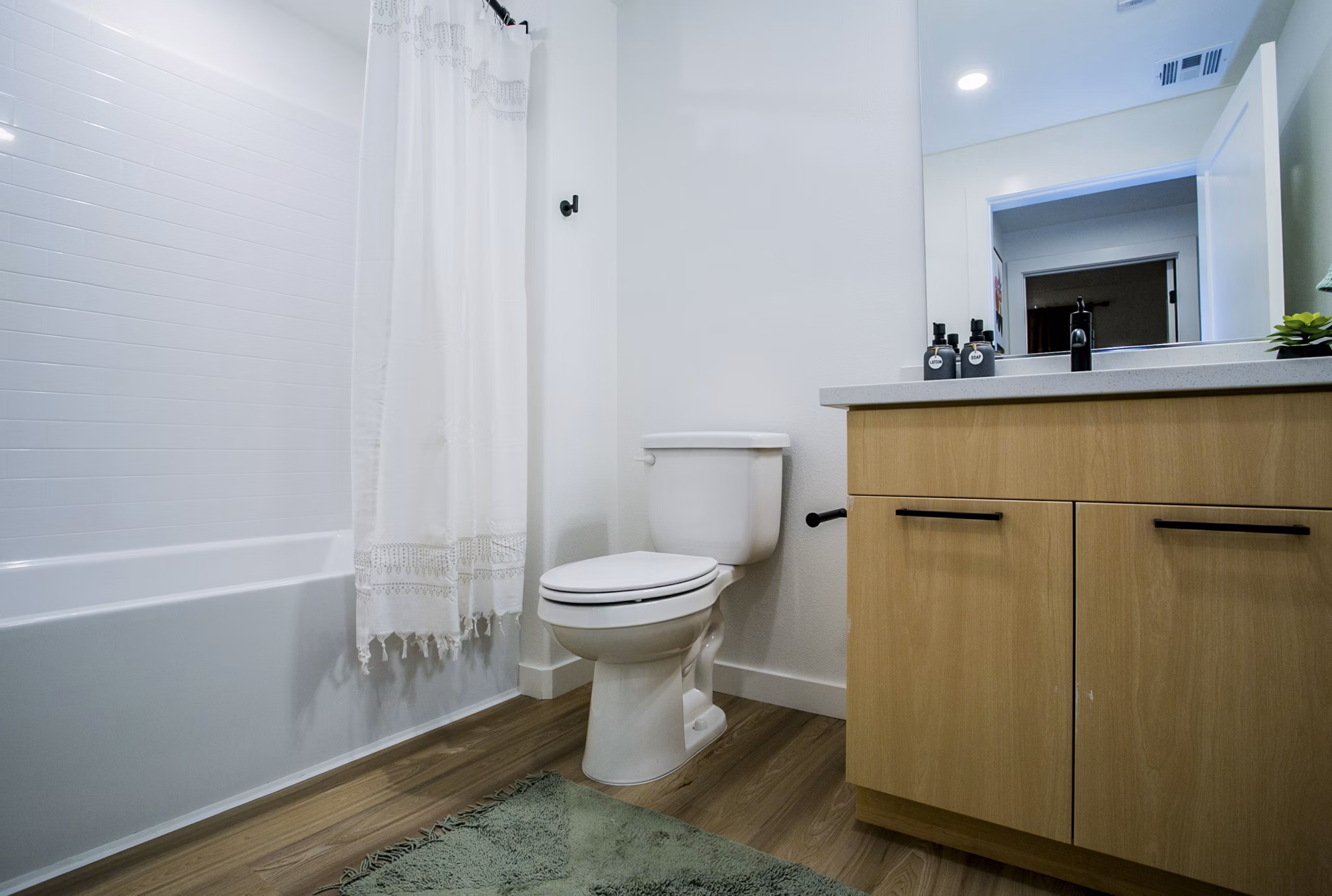 Spacious bathroom with modern fixtures at Alma Apartments