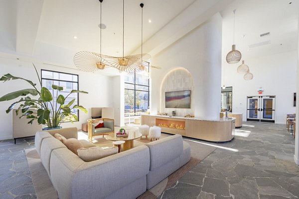 Clubhouse with modern furnishings and vibrant decor at Alma Apartments