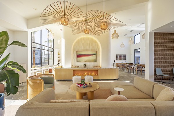 Modern clubhouse with cozy seating and game areas at Alma Apartments, a Greystar luxury living community
