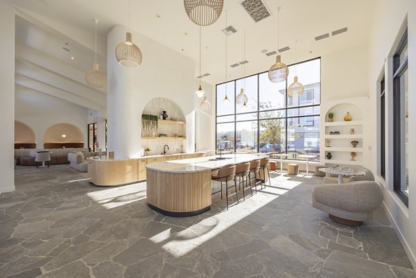 Modern clubhouse with cozy seating and community areas at Alma Apartments