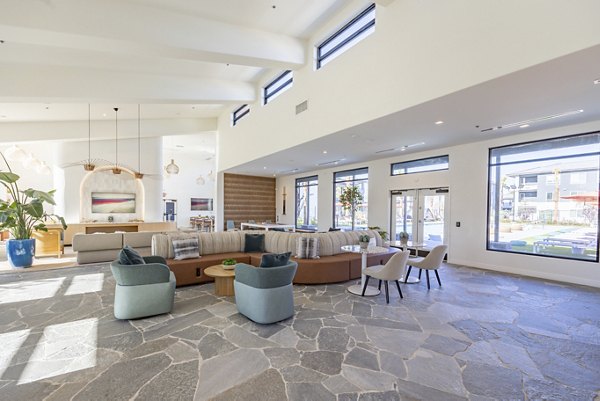 Modern clubhouse with stylish seating and vibrant decor at Alma Apartments