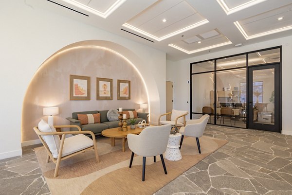 Clubhouse featuring modern design and seating areas at Alma Apartments