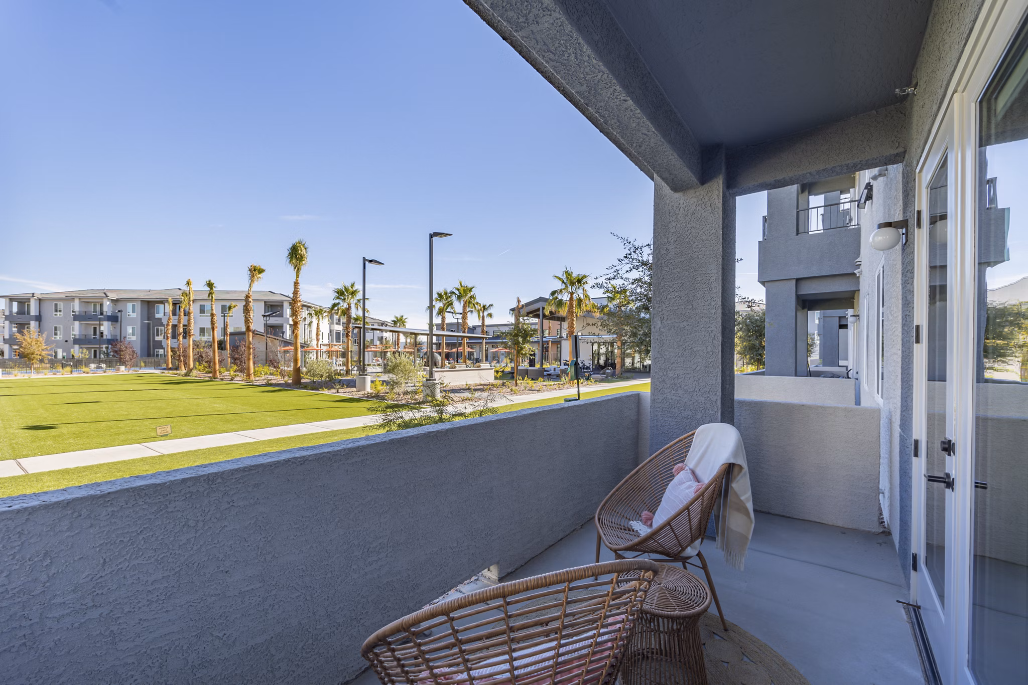 Cozy outdoor patio with stylish seating at Alma Apartments, perfect for relaxation and social gatherings