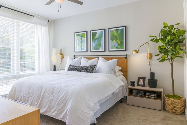 Bedroom featuring modern decor and ample natural light at The Cynwyd Apartments