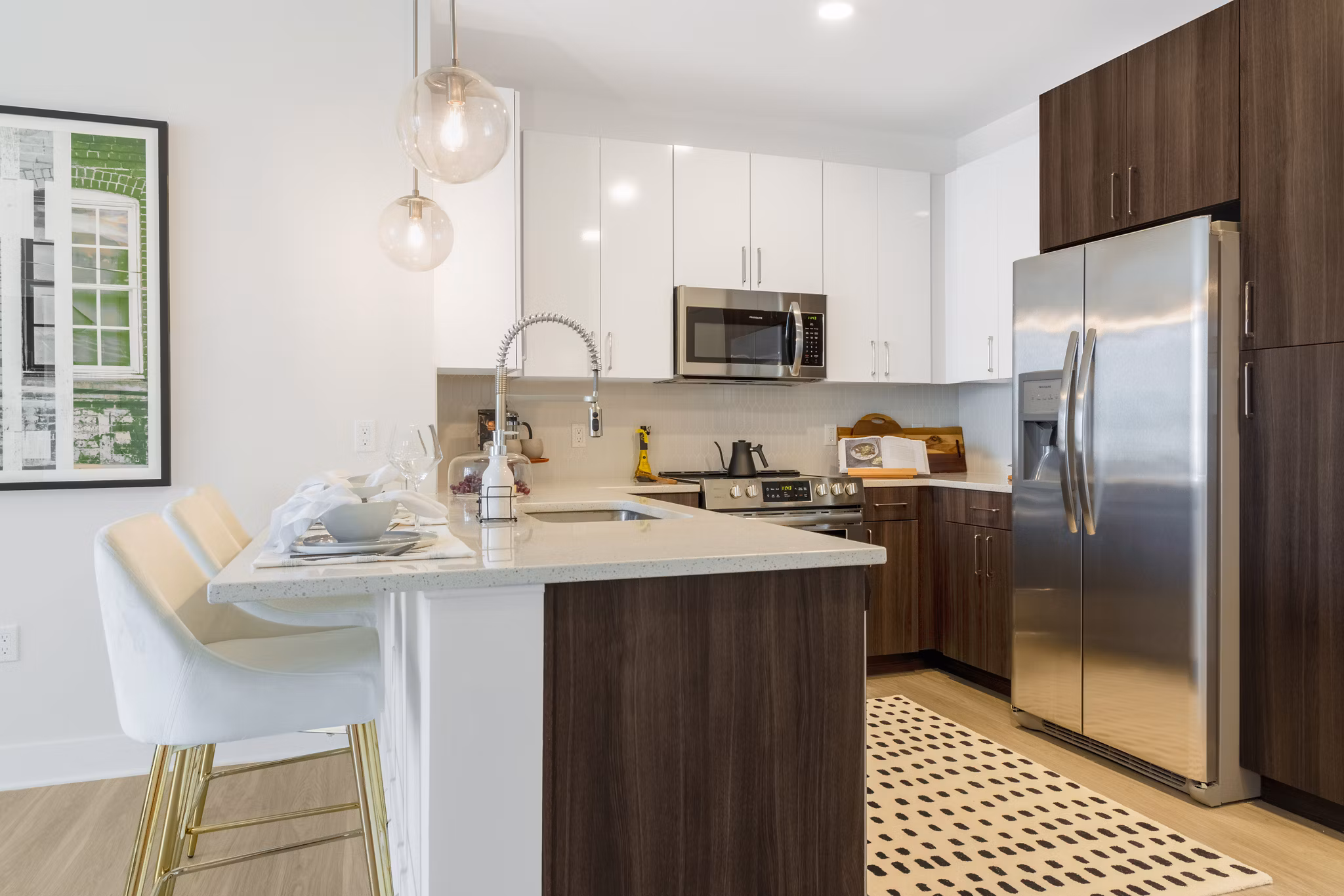 Modern kitchen with stainless steel appliances in The Cynwyd Apartments
