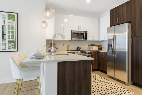 Modern kitchen with stainless steel appliances in The Cynwyd Apartments