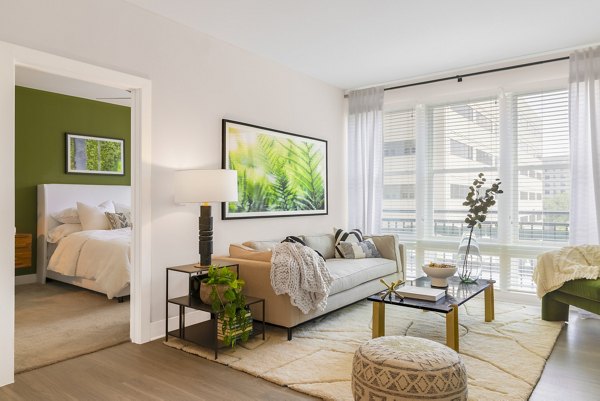 Spacious living room with modern decor and large windows in The Cynwyd Apartments, luxury living near Philadelphia