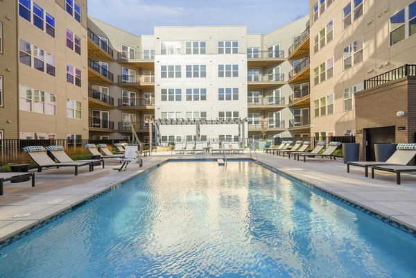 Resort-style pool with lounge chairs at The Cynwyd Apartments