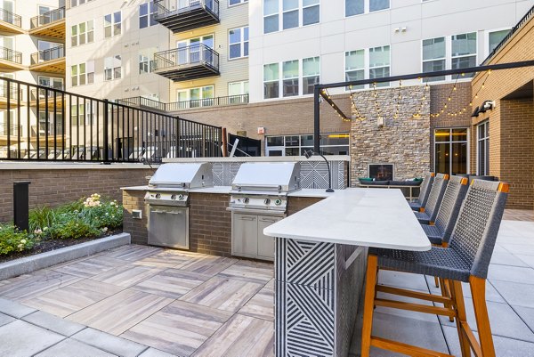 Outdoor grilling area with modern amenities at The Cynwyd Apartments, perfect for social gatherings and alfresco dining