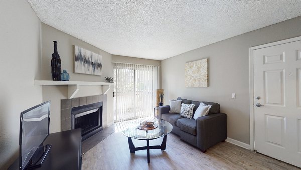 Spacious living room with modern decor in Glen at the Park Apartments