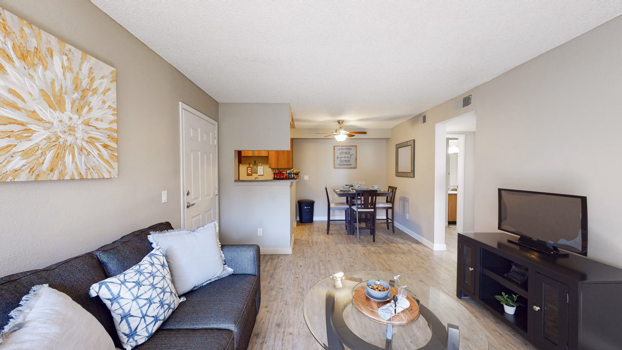 Modern living room with large windows and stylish furnishings at Glen at the Park Apartments