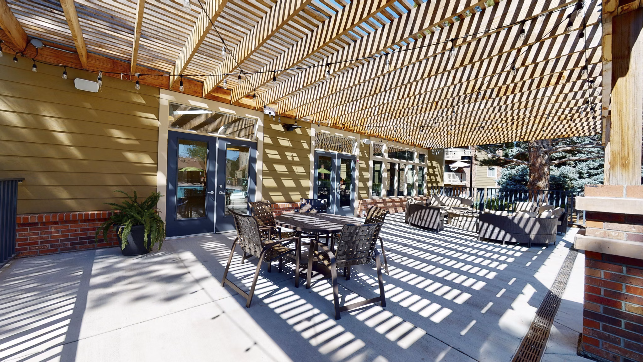 Glen at the Park Apartments: Cozy patio with outdoor seating and greenery, offering a relaxing retreat for residents