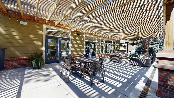 Glen at the Park Apartments: Cozy patio with outdoor seating and greenery, offering a relaxing retreat for residents