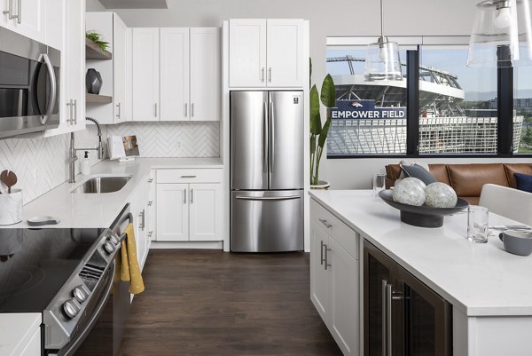 Kitchen with modern appliances and sleek countertops in 1919 Mile High Apartments