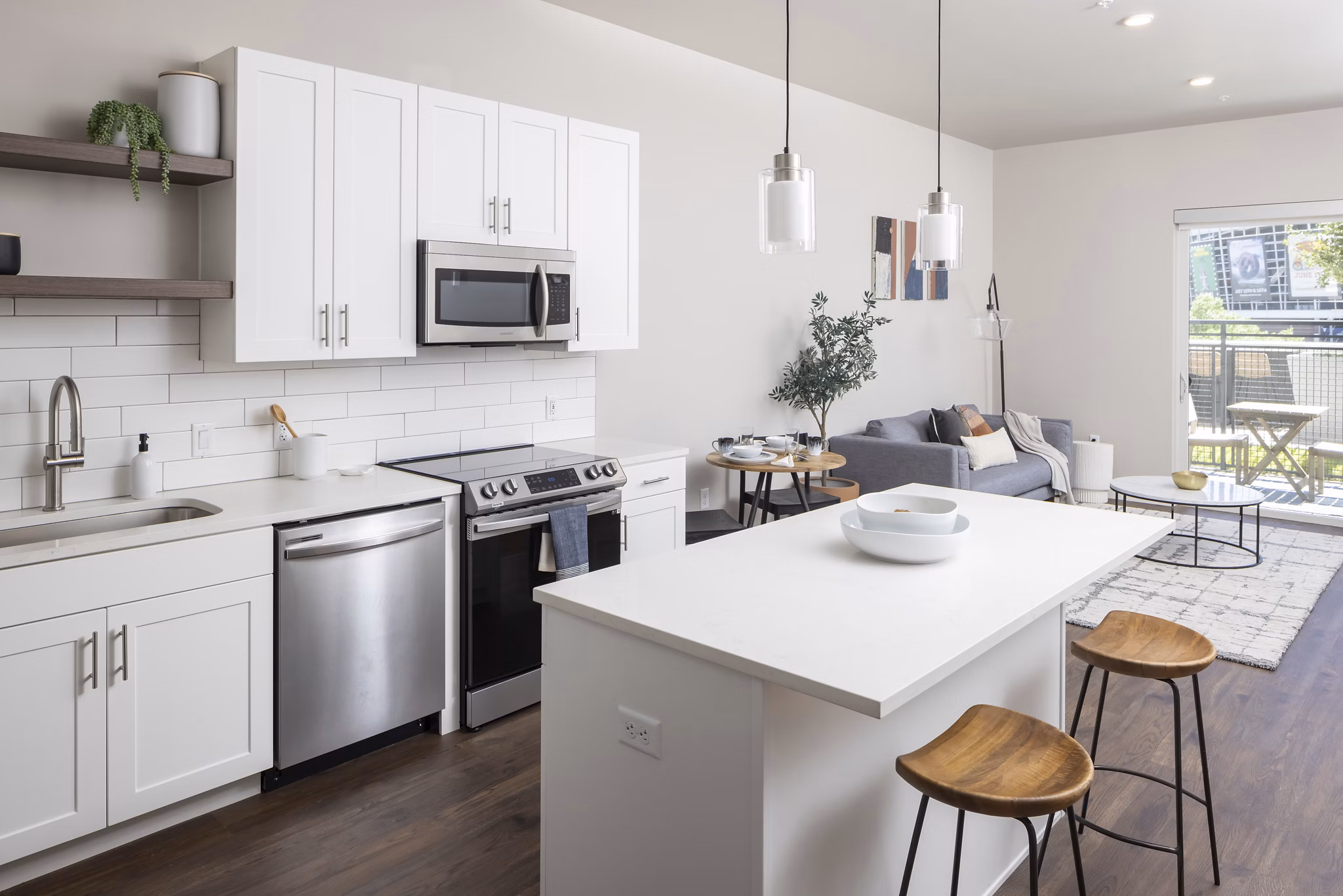 Modern kitchen with stainless steel appliances and granite countertops at 1919 Mile High Apartments