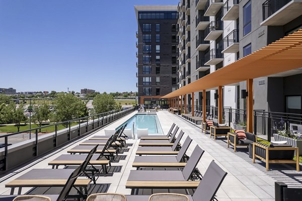 Rooftop pool with city skyline views at 1919 Mile High Apartments