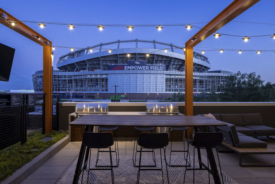Grill area with modern seating and BBQ facilities at 1919 Mile High Apartments