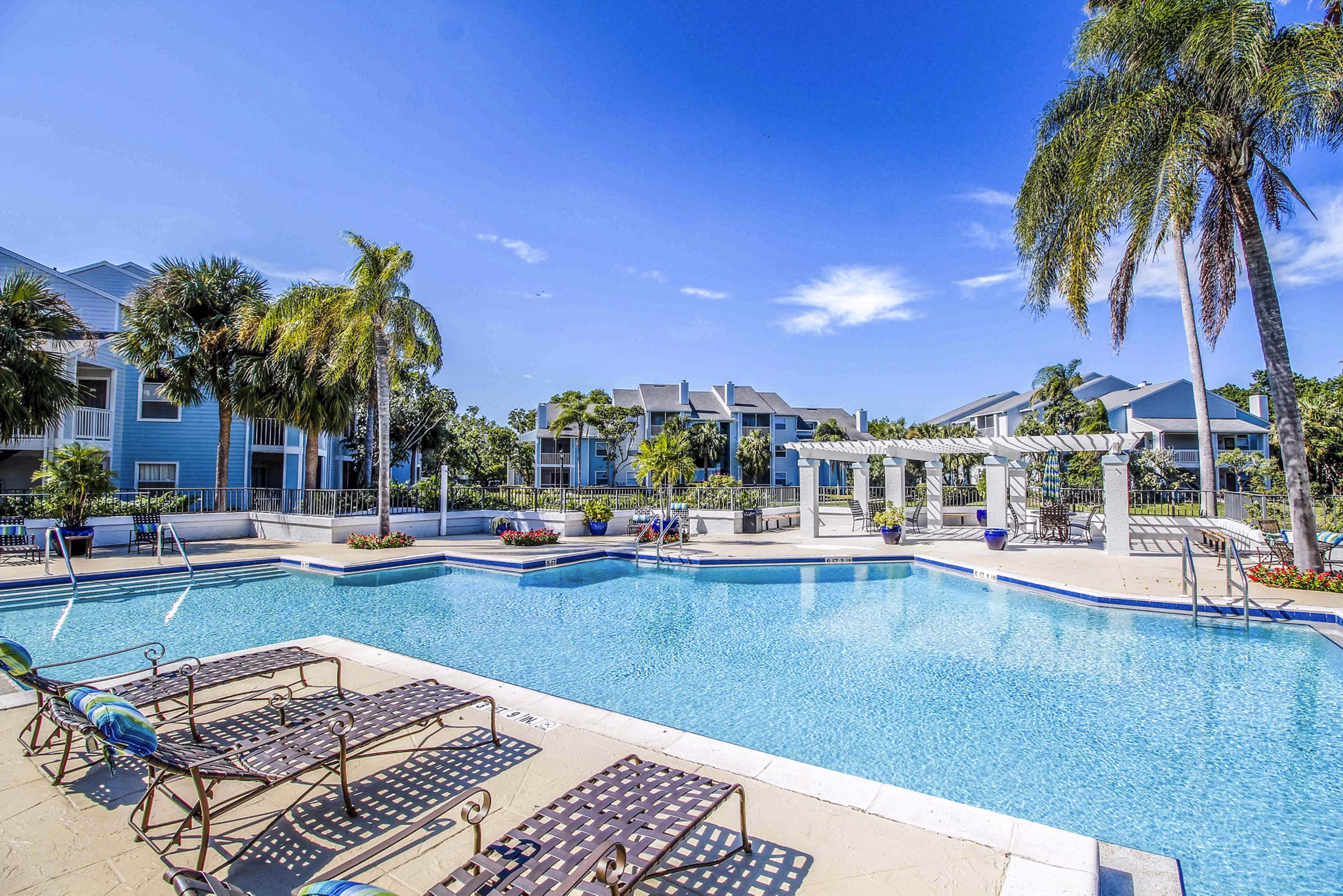 Relaxing pool area with sun loungers at The Retreat at Vista Lake Apartments