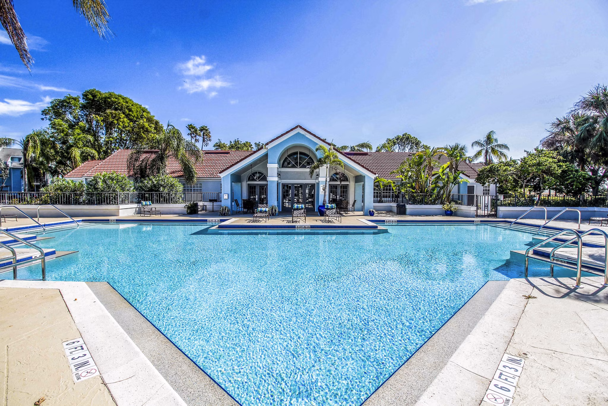 Inviting poolside oasis at The Retreat at Vista Lake Apartments, surrounded by lush landscaping, perfect for relaxation and leisure activities