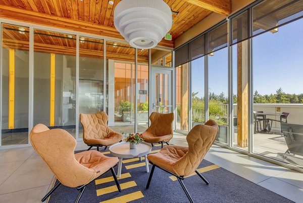 Clubhouse with modern seating and pool table at Arras Apartments, a Greystar luxury apartment community