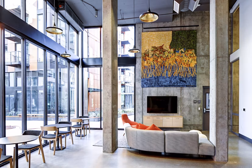 Modern clubhouse with comfortable seating and entertainment options at Arras Apartments, perfect for luxury gatherings in a vibrant community setting