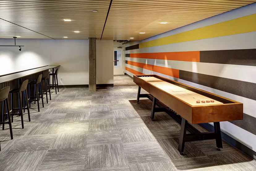 Stylish clubhouse with modern seating and entertainment options at Arras Apartments, luxury community living