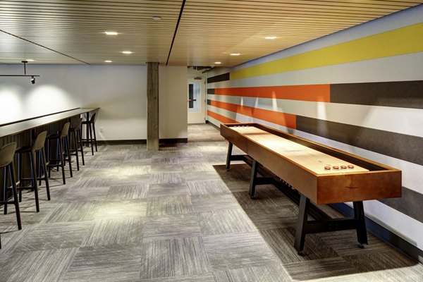 Stylish clubhouse with modern seating and entertainment options at Arras Apartments, luxury community living