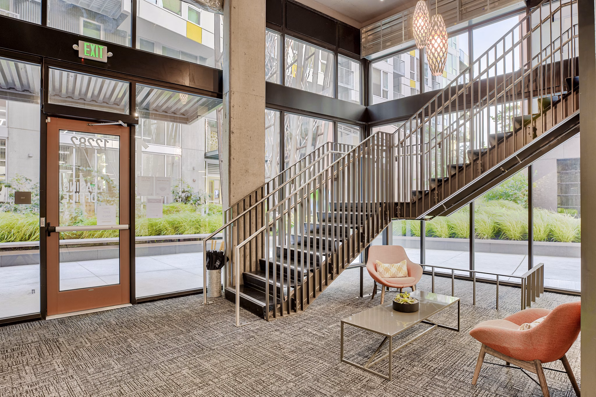 Clubhouse featuring modern lounge seating and pool table at Arras Apartments, a luxury property in vibrant downtown area