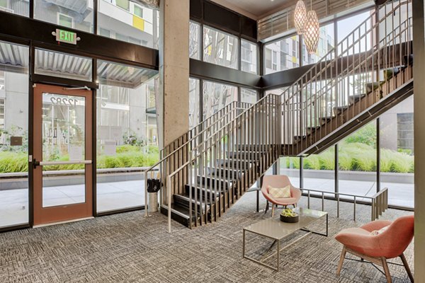 Clubhouse featuring modern lounge seating and pool table at Arras Apartments, a luxury property in vibrant downtown area