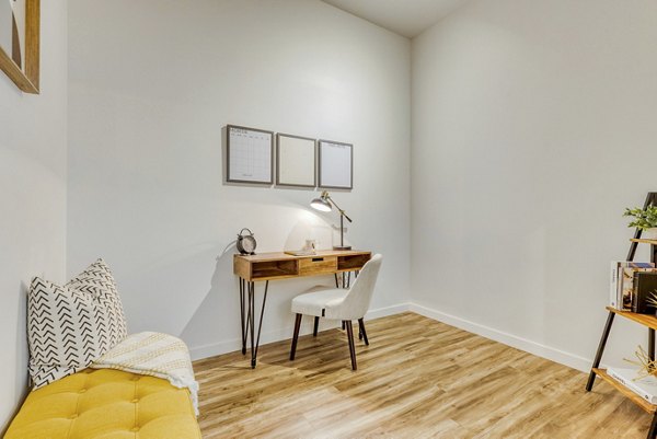 Home office featuring modern desk and ergonomic chair at Arras Apartments