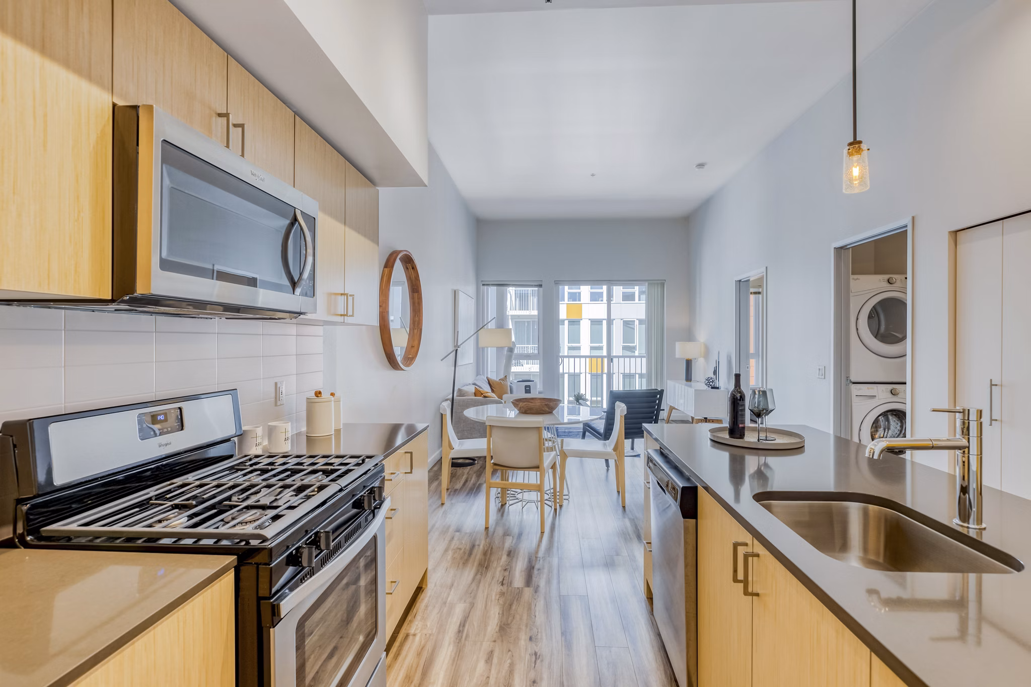 Modern kitchen with stainless steel appliances and island at Arras Apartments