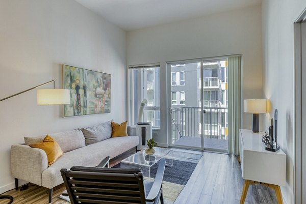 Spacious living room with modern furnishings at Arras Apartments
