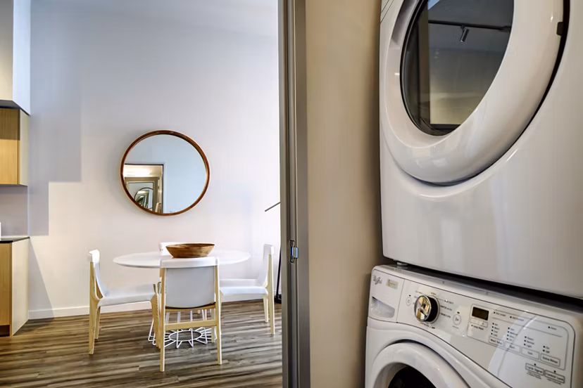 Laundry room featuring high-efficiency washers and dryers at Arras Apartments