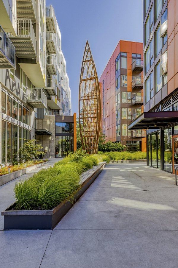 Arras Apartments: Lush courtyard with seating and greenery for relaxation