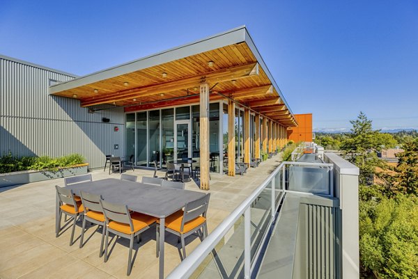 Skyline-view rooftop deck at Arras Apartments, featuring modern seating and greenery, perfect for relaxation and social gatherings