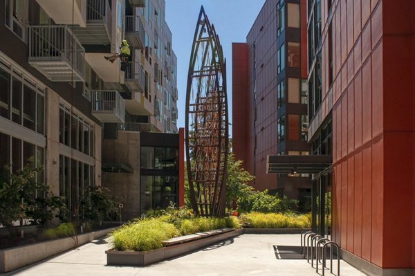 Courtyard with lush gardens and seating at Arras Apartments