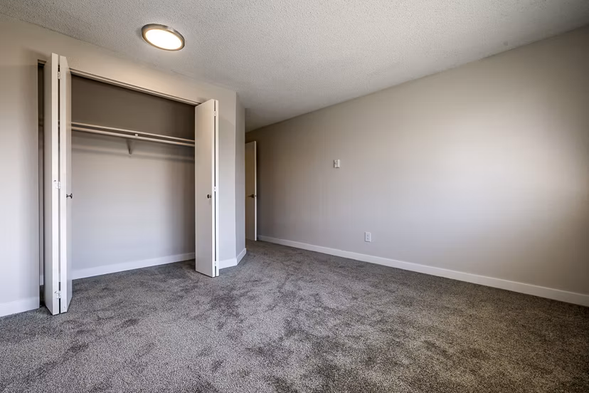 Cozy bedroom with modern decor at 1202 Pearl Apartments, highlighting a serene atmosphere for relaxation