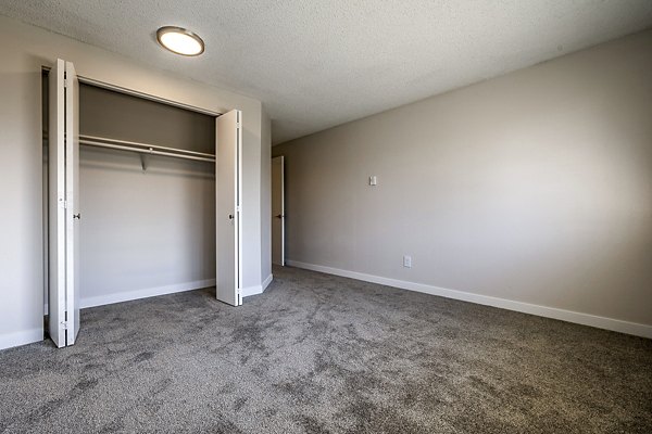 Cozy bedroom with modern decor at 1202 Pearl Apartments, highlighting a serene atmosphere for relaxation