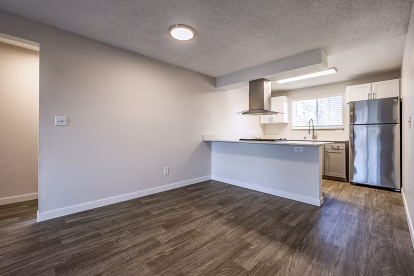 Elegant dining room with modern decor at 1202 Pearl Apartments, featuring stylish furniture and large windows