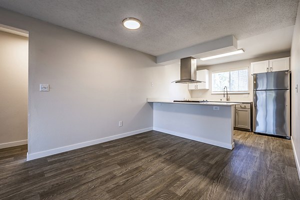 Elegant dining room with modern decor at 1202 Pearl Apartments, featuring stylish furniture and large windows