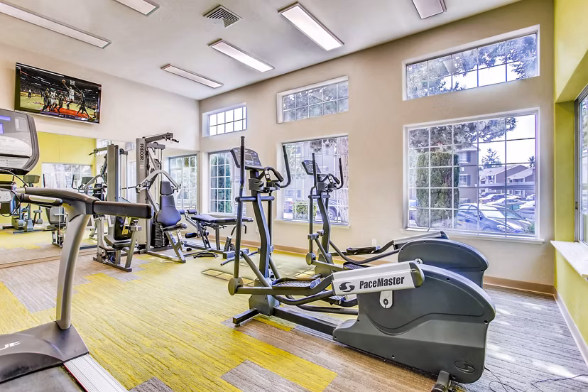 State-of-the-art fitness center at 1202 Pearl Apartments offering modern equipment and spacious workout areas for residents dedicated to wellness