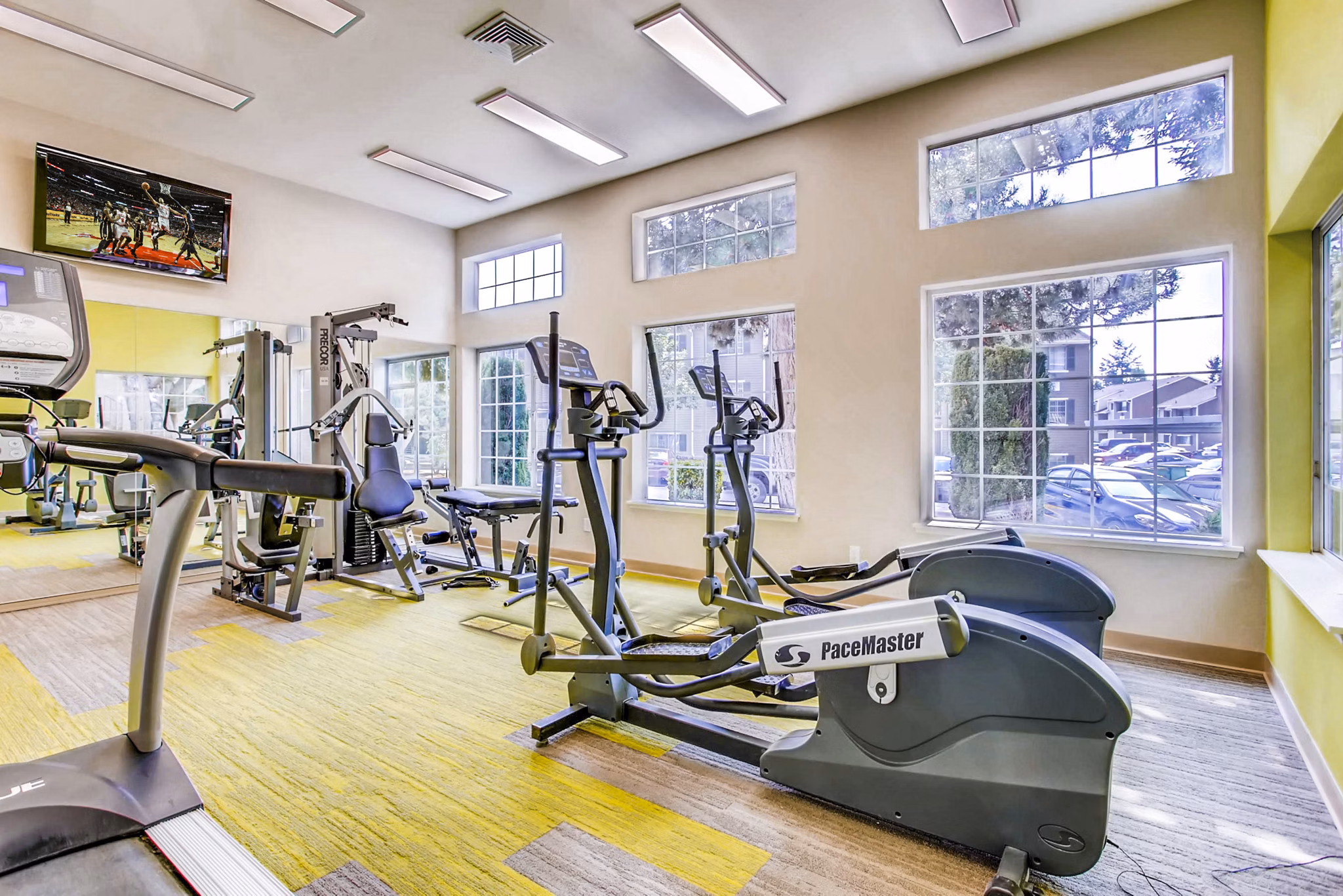 State-of-the-art fitness center at 1202 Pearl Apartments offering modern equipment and spacious workout areas for residents dedicated to wellness