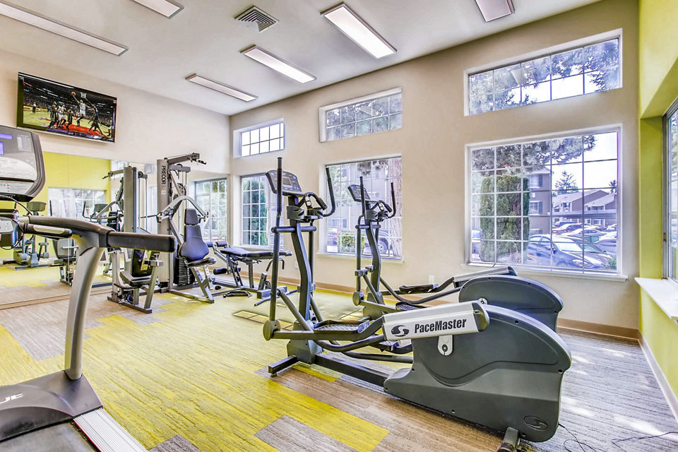 State-of-the-art fitness center at 1202 Pearl Apartments offering modern equipment and spacious workout areas for residents dedicated to wellness