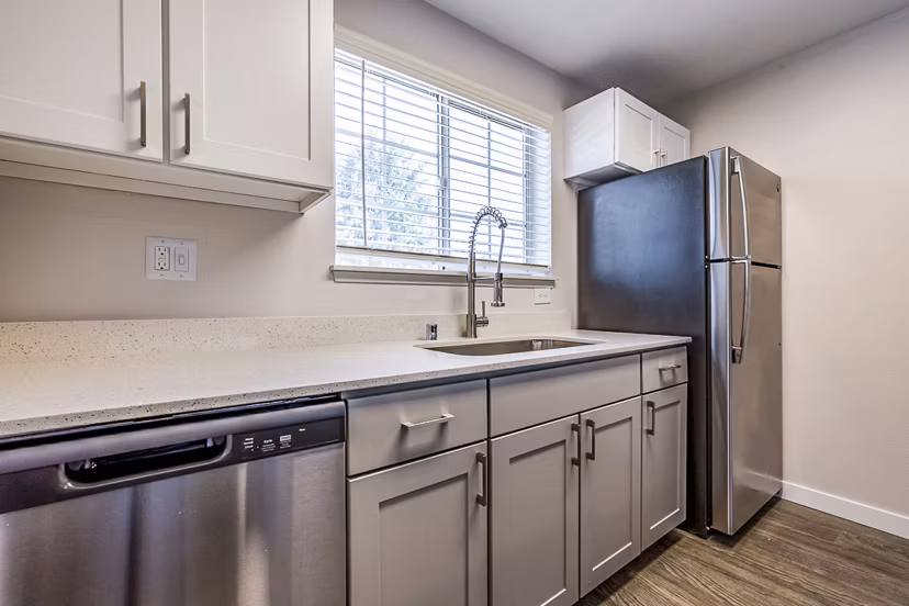 Modern kitchen with stainless steel appliances in 1202 Pearl Apartments luxury complex