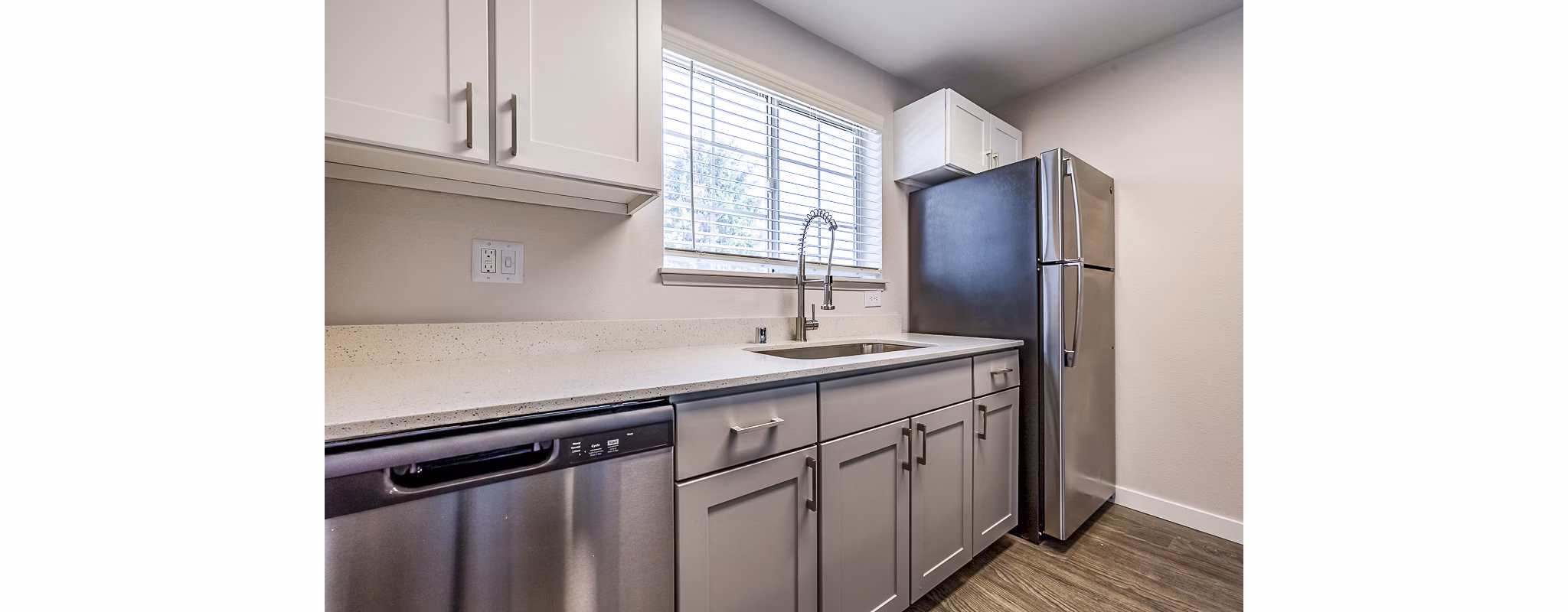 Modern kitchen with stainless steel appliances in 1202 Pearl Apartments luxury complex