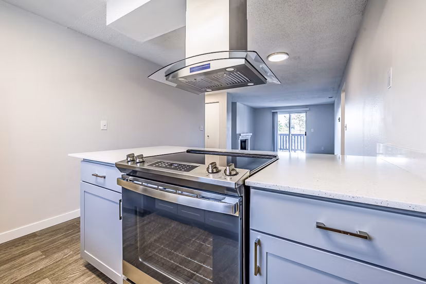 Modern kitchen with stainless steel appliances in 1202 Pearl Apartments