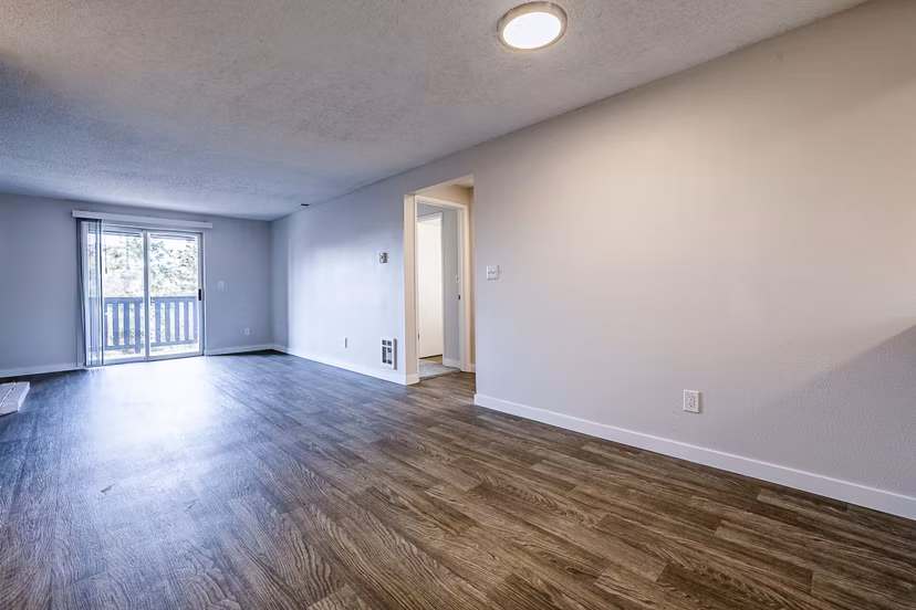 Spacious living room with contemporary furnishings at 1202 Pearl Apartments